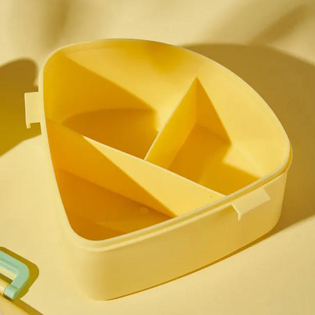 Yellow kawaii bento box with compartments on a matching yellow background