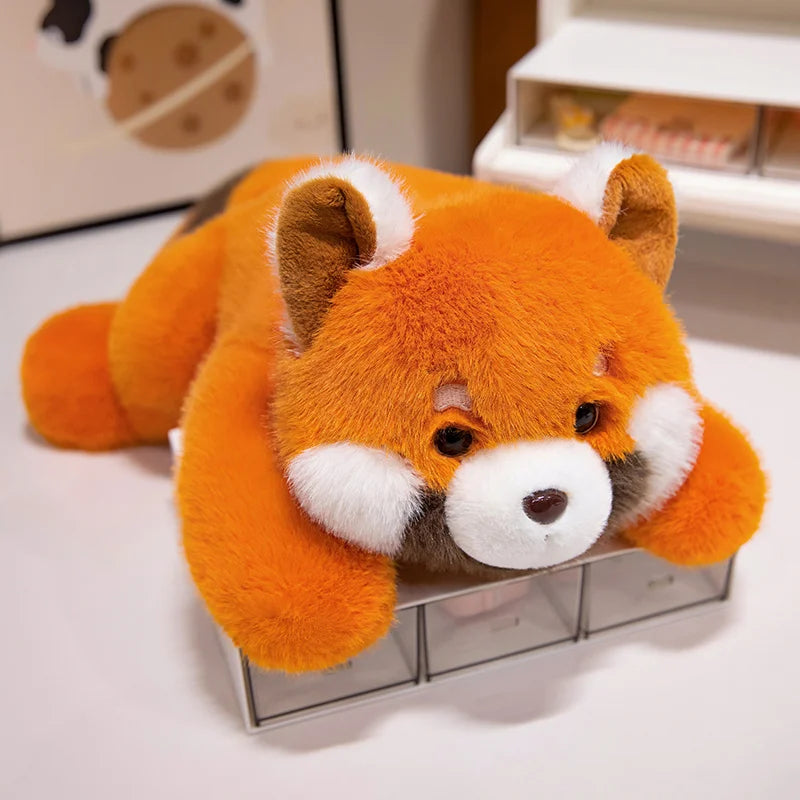Kawaii plush toy red panda lying on a glass surface
