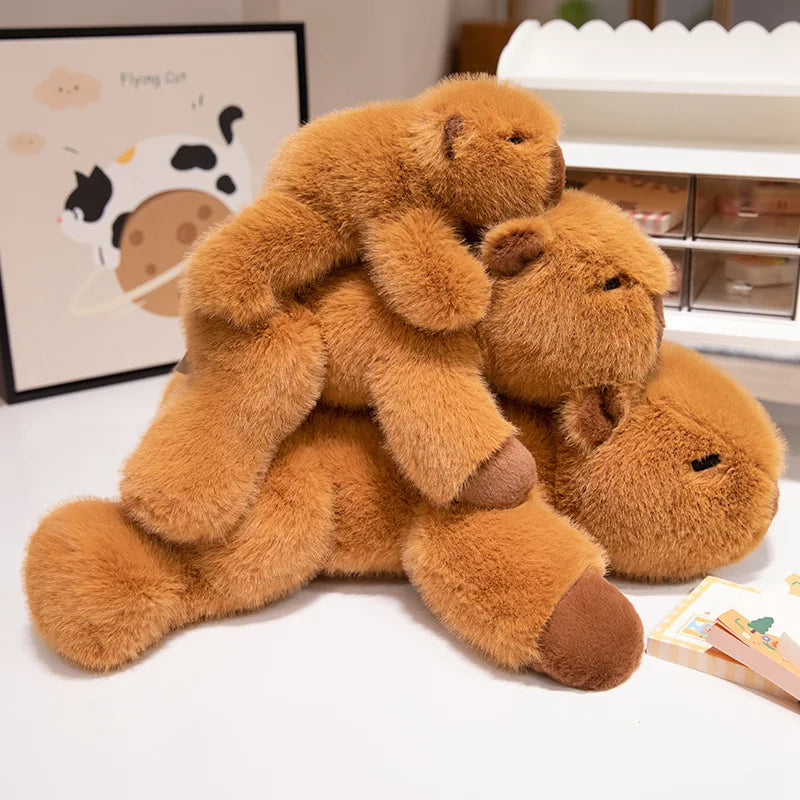 Three brown kawaii teddy bears of different sizes on a white surface with a blurred background.