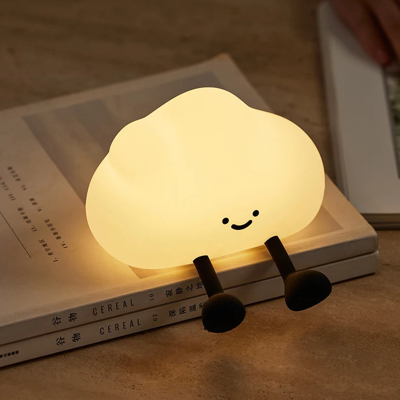 Cute cloud-shaped kawaii night light on a stack of books