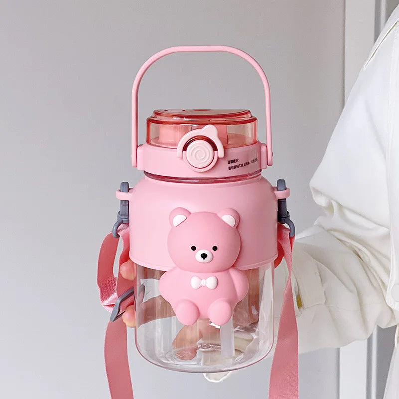 Pink bear-themed kawaii water bottle with a clear body and pink lid on a light gray background