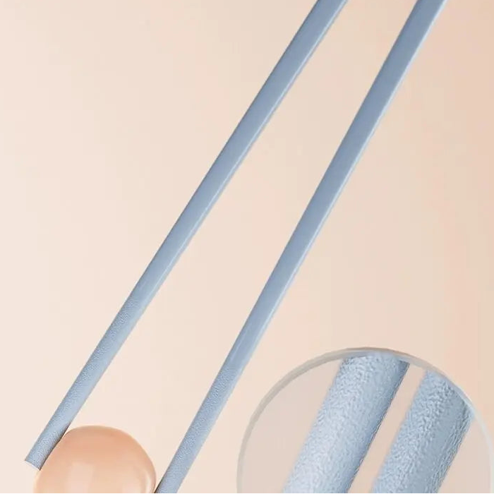 Blue kawaii chopsticks held by a hand with text on a beige background