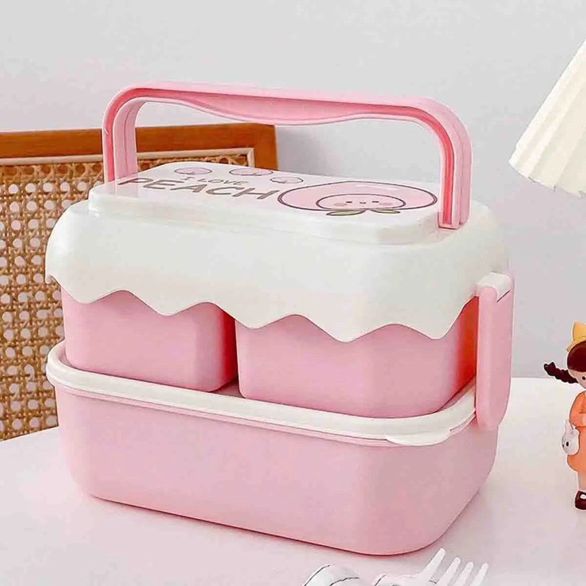 Pink kawaii lunch box with cartoon character on a white surface
