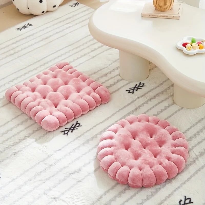 Two pink textured kawaii pillows on a white rug with a light-colored table in the background.