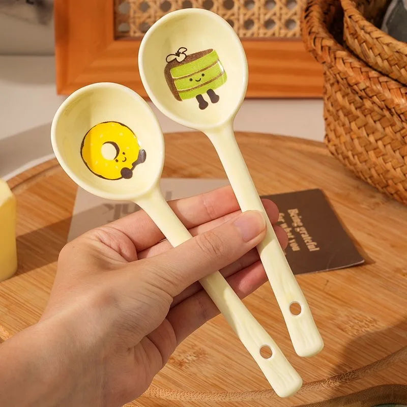 A person holding two white kawaii spoons