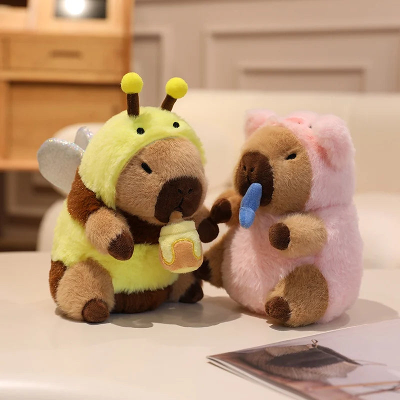 Two kawaii plush toys, one in a bee costume and the other in a pink outfit, sitting on a surface.