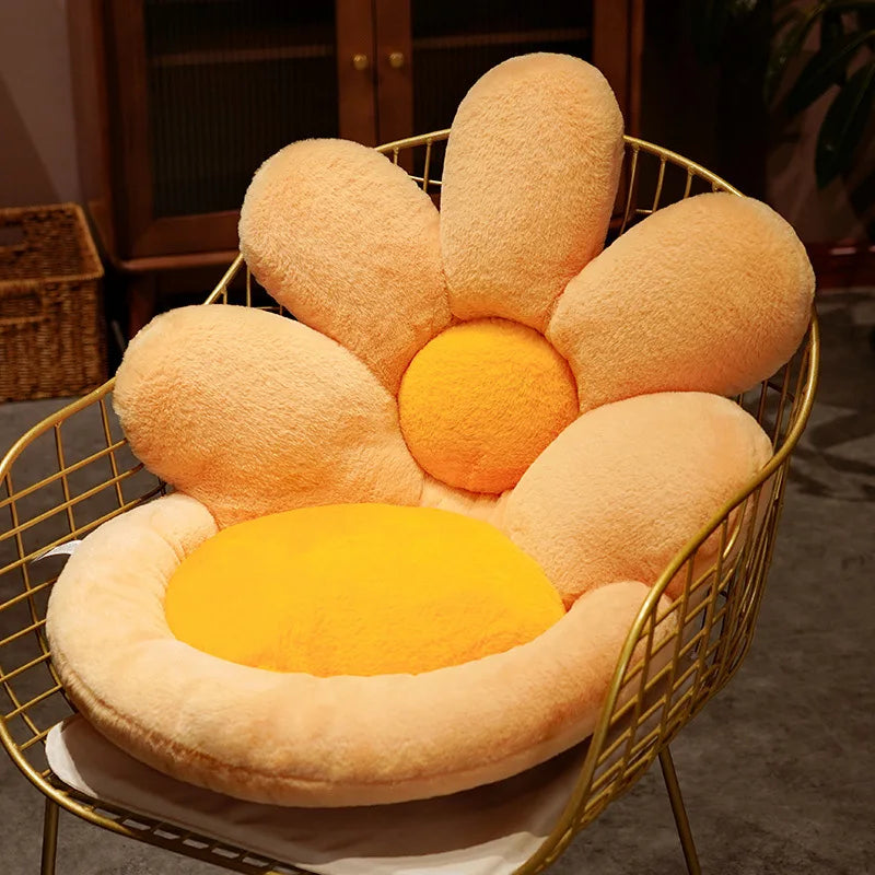 Flower-shaped kawaii cushion with a yellow center on a wire chair in a room setting.