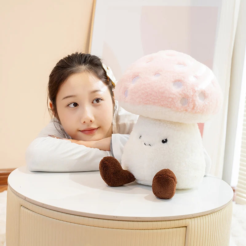 Person sitting behind a kawaii plush mushroom toy on a table