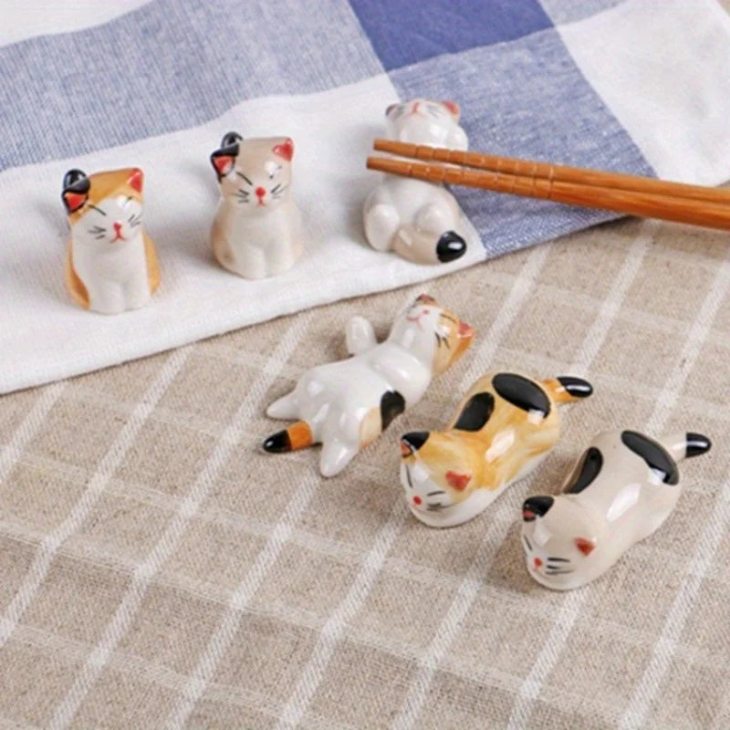 Set of cat-shaped ceramic kawaii chopstick holder on a checkered tablecloth