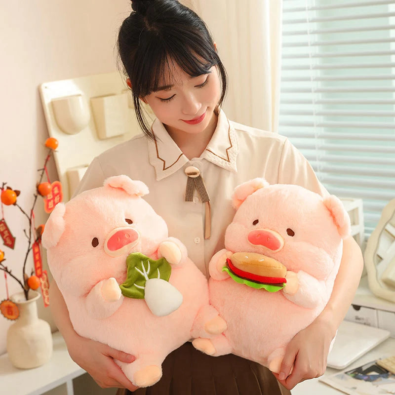 Person holding two kawaii plush pig toys with a burger and salad design.