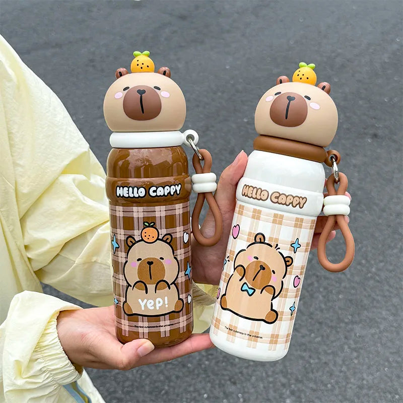 Two cartoon bear-themed kawaii water bottles held by a person on a gray background