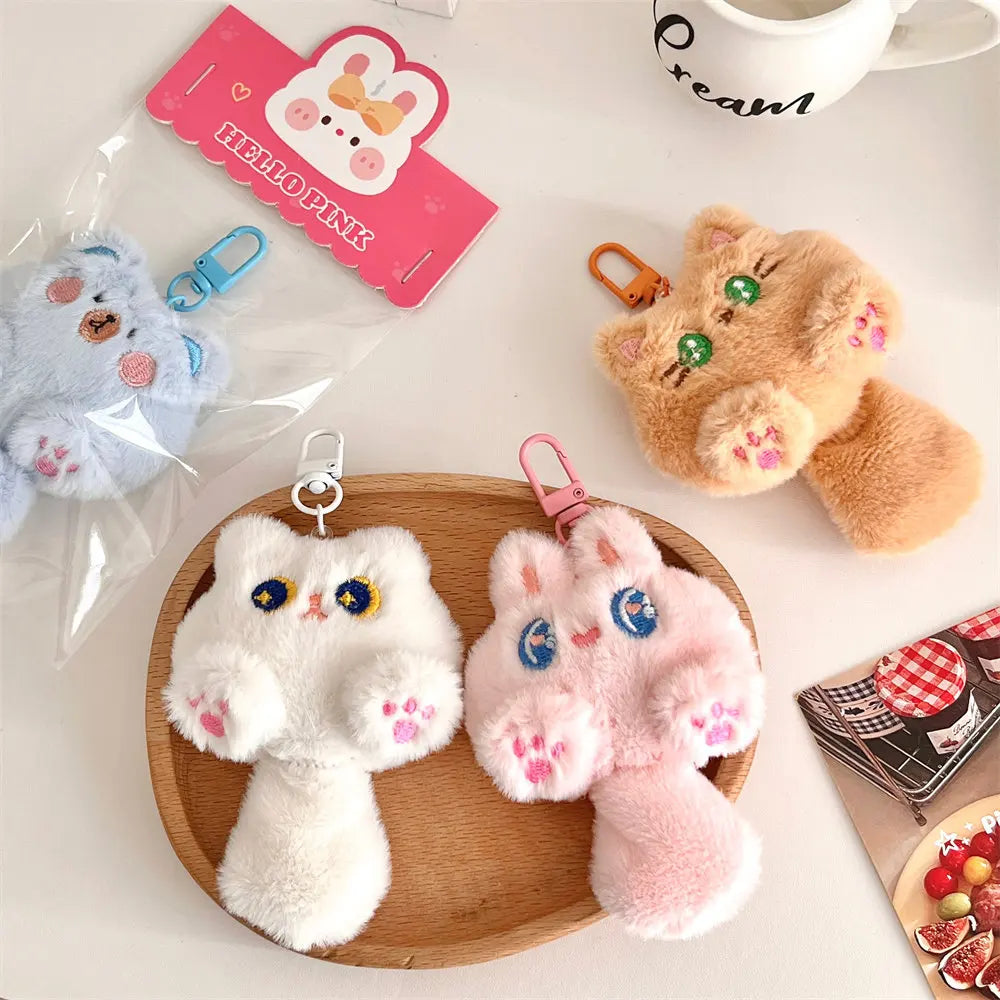 Plush kawaii keychains on a wooden plate with a white background