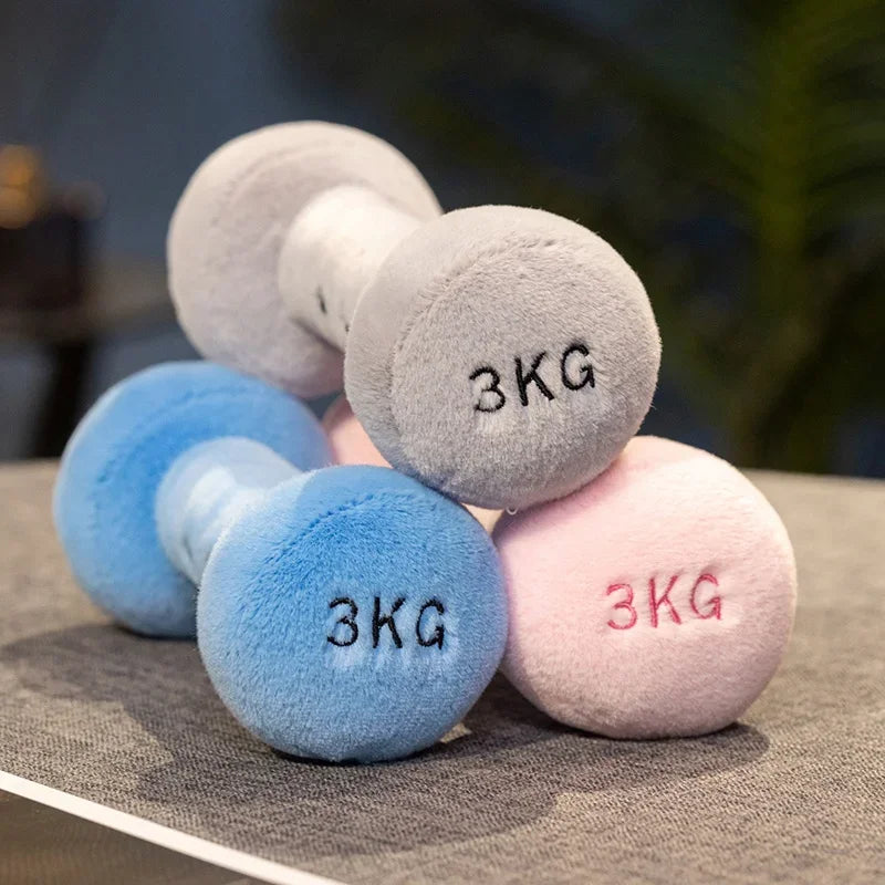 Set of three small kawaii plush dumbbells in gray, blue, and pink with '3KG' marking on a neutral background.
