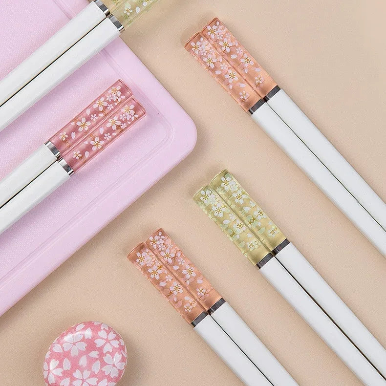 Set of decorative kawaii chopsticks with floral designs on a beige background