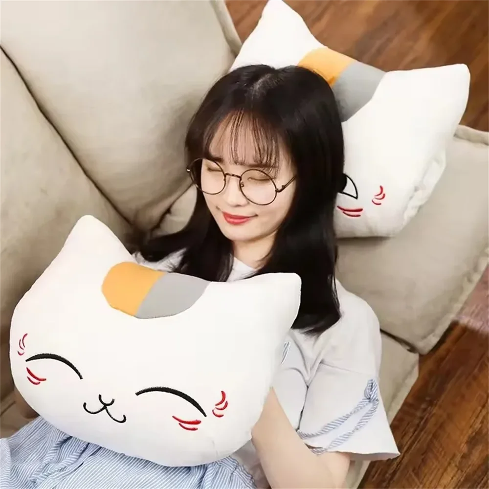Woman sitting on a couch with a large kawaii cat-shaped pillow