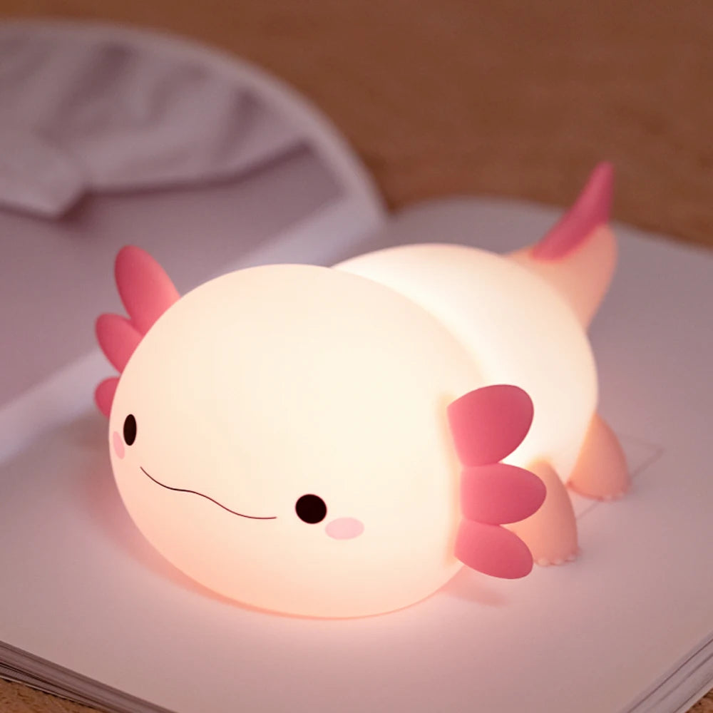 Cute kawaii axolotl-shaped night light on a book