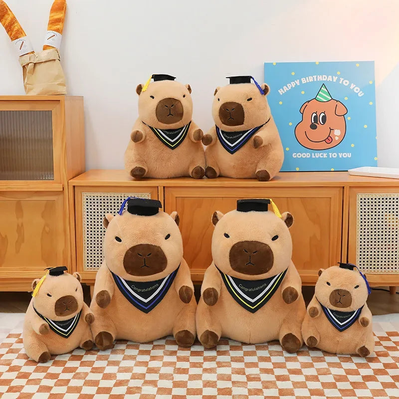 Set of kawaii plush bears with graduation caps and gowns on a checkered floor.