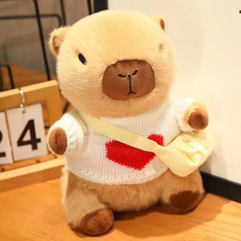 Kawaii plush bear toy wearing a sweater with a red heart on a wooden surface.