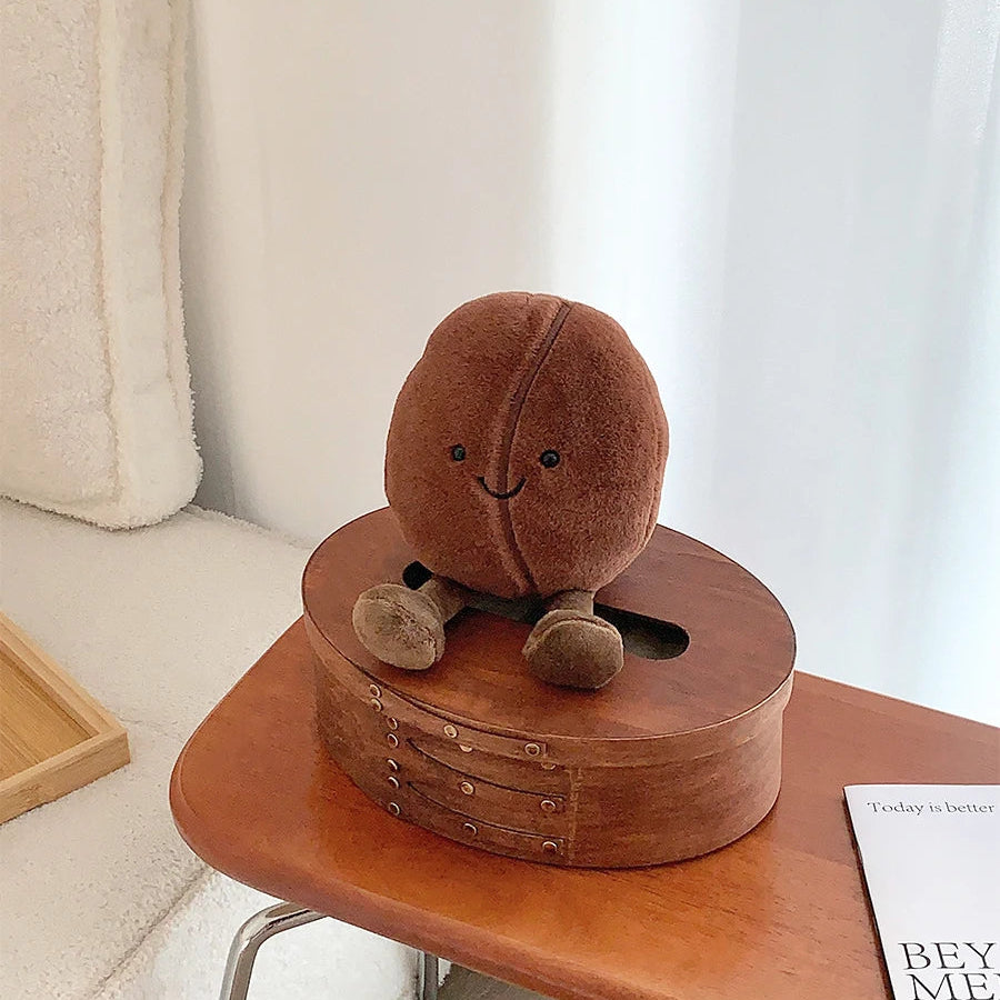Brown kawaii plush toy on a wooden box on a table with a neutral background