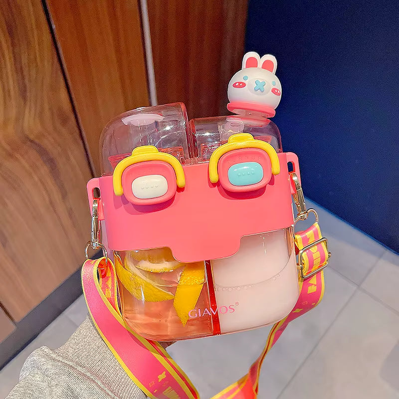 Pink and yellow kawaii water bottle holder with a small rabbit-shaped container on top, against a wooden and blue wall background.