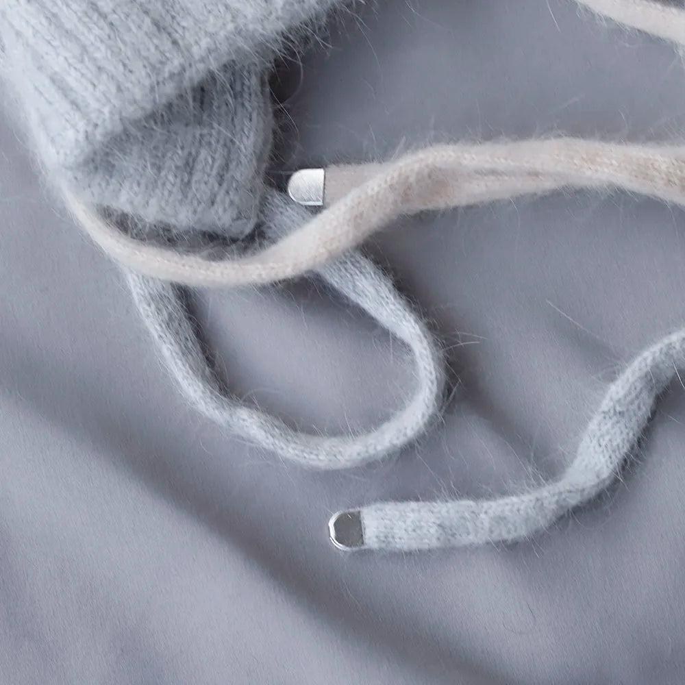 Close-up of gray Kawaii hat on a gray fabric background