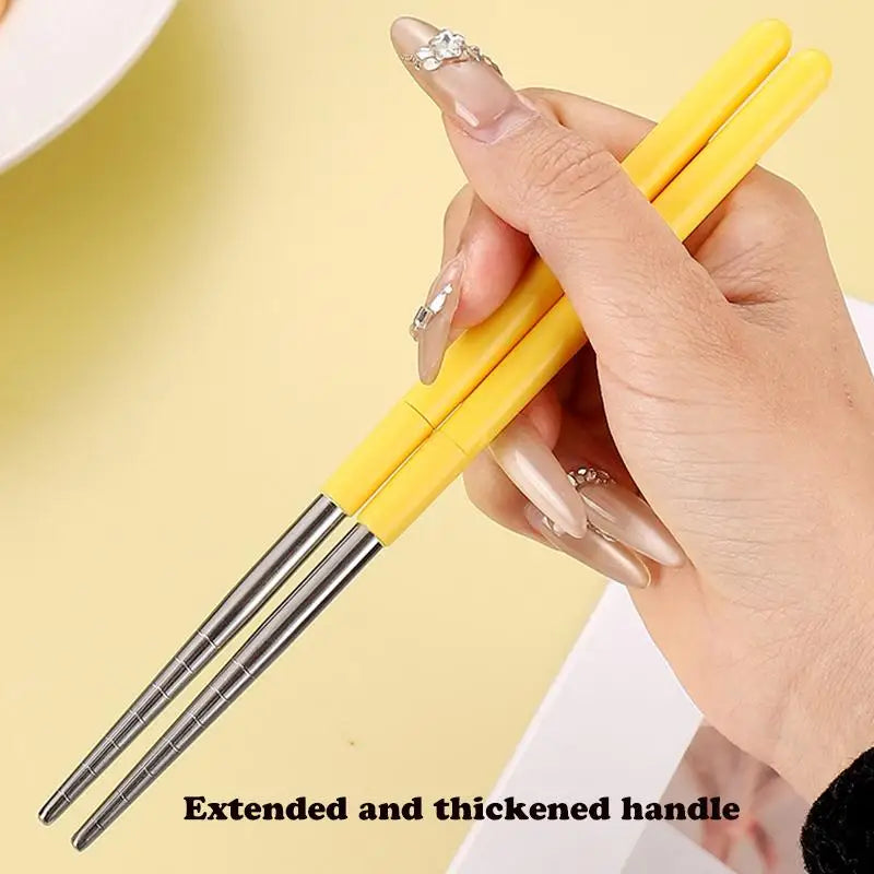 Someone holding a pair of yellow kawaii utensils