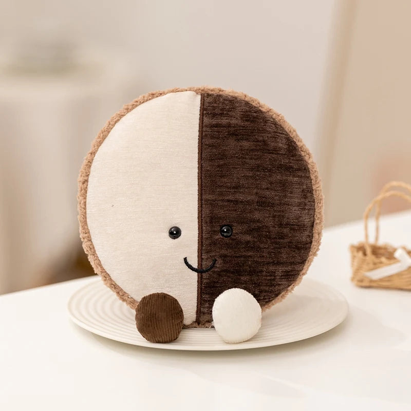 Round kawaii plush toy with half white and half brown on a white plate