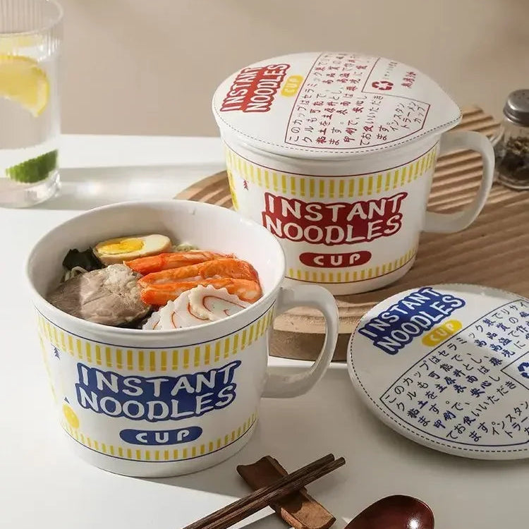 Instant noodles kawaii ramen bowls with a lid on a table with a glass of water and lime.