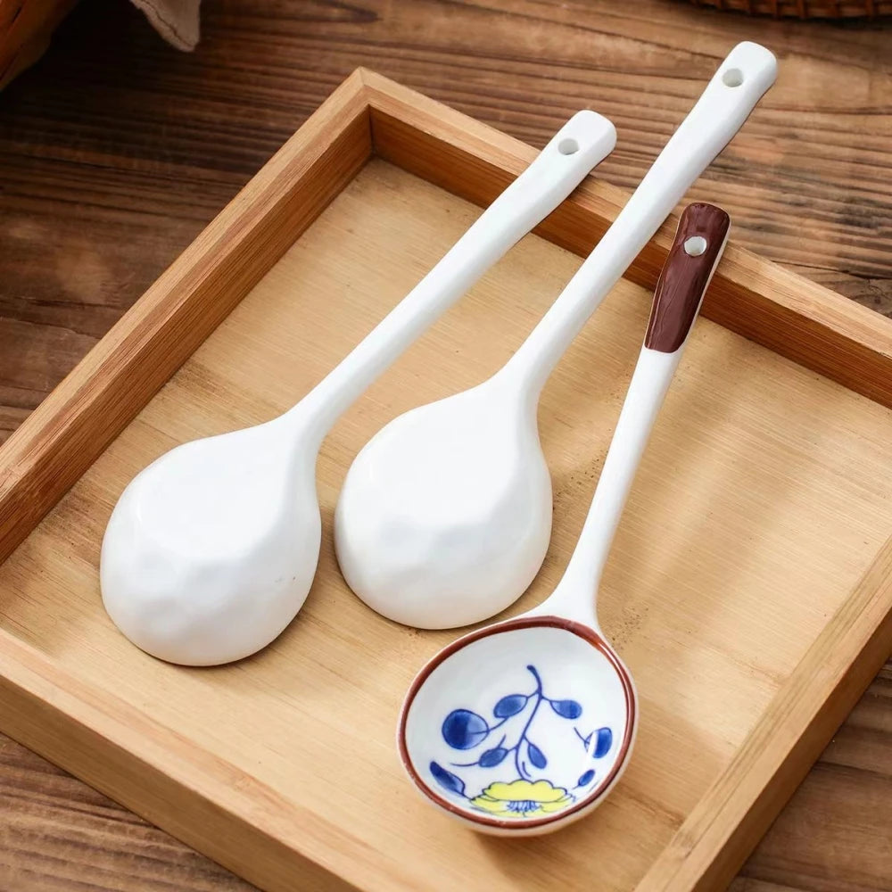 Three white ceramic kawaii spoons on a tray