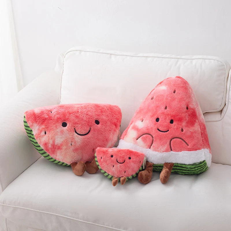 Set of three kawaii plush watermelon toys on a white couch