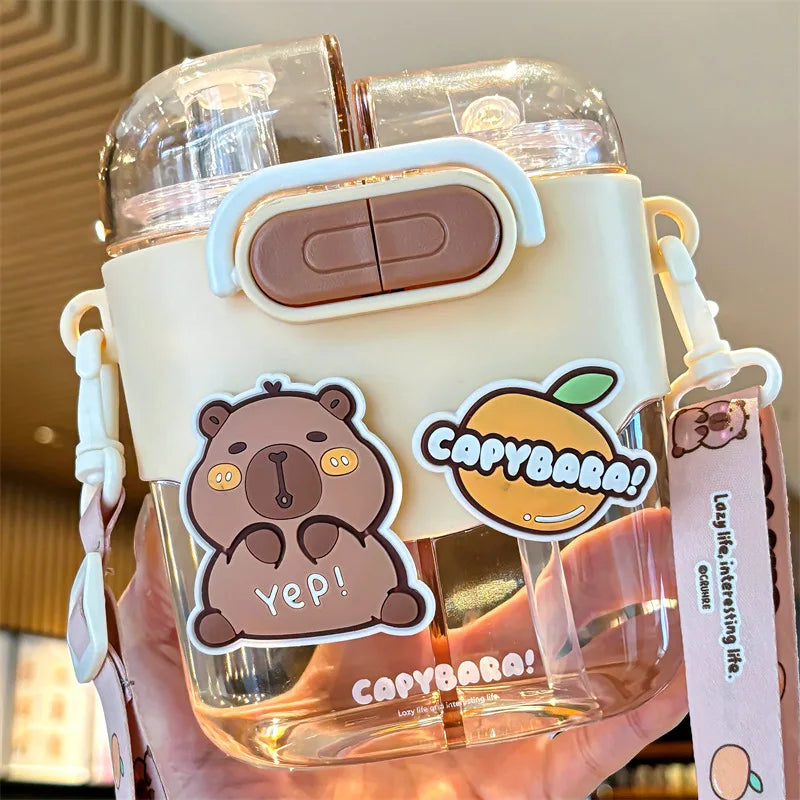 Clear kawaii water bottle with cartoon bear and orange design, featuring 'Capybara!' branding.