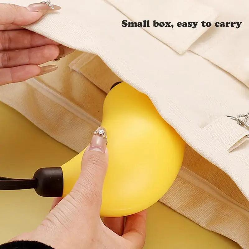 Someone placing a banana shaped kawaii utensils case in a bag