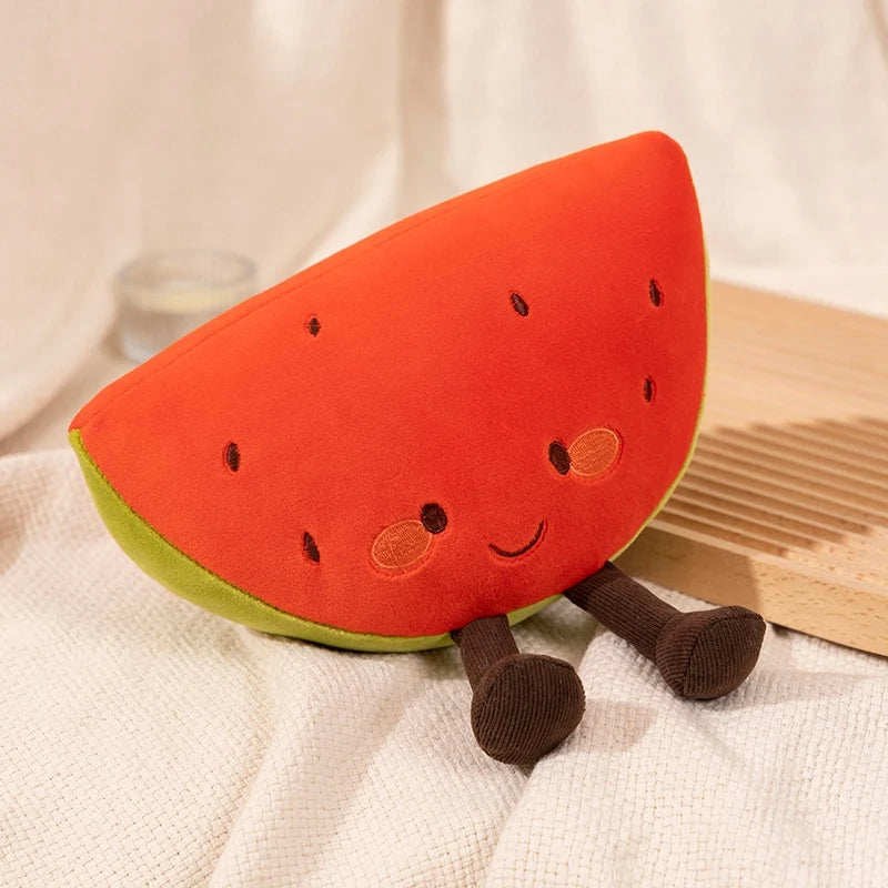 Plush toy shaped like a watermelon slice with legs and a face on a white fabric background.
