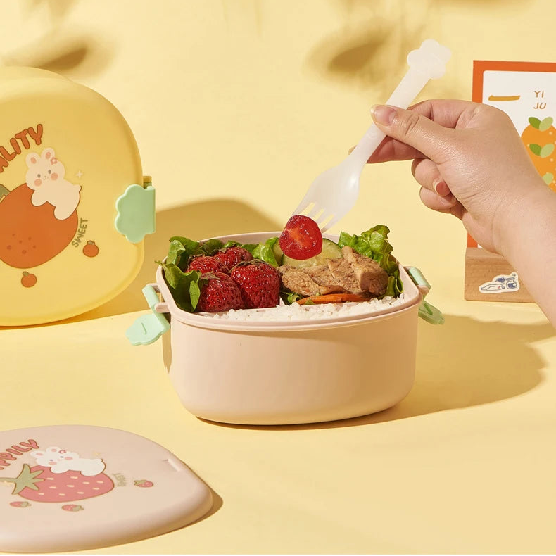 Person holding a fork over a salad in a pink kawaii container on a yellow background