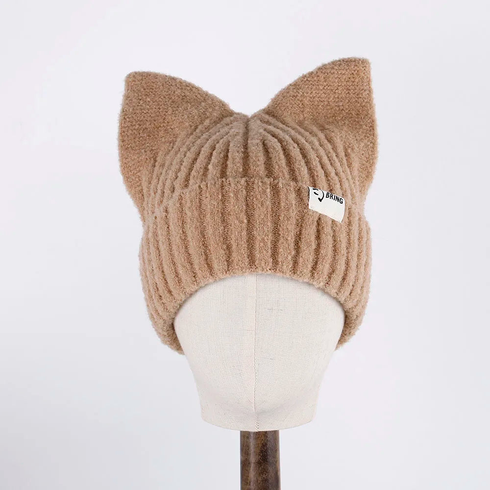 Beige knitted cat ear Kawaii hat on a mannequin head against a white background