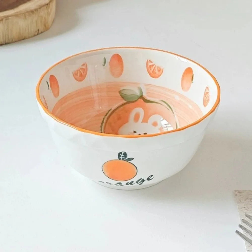A orange designed kawaii ramen bowl on a kitchen counter