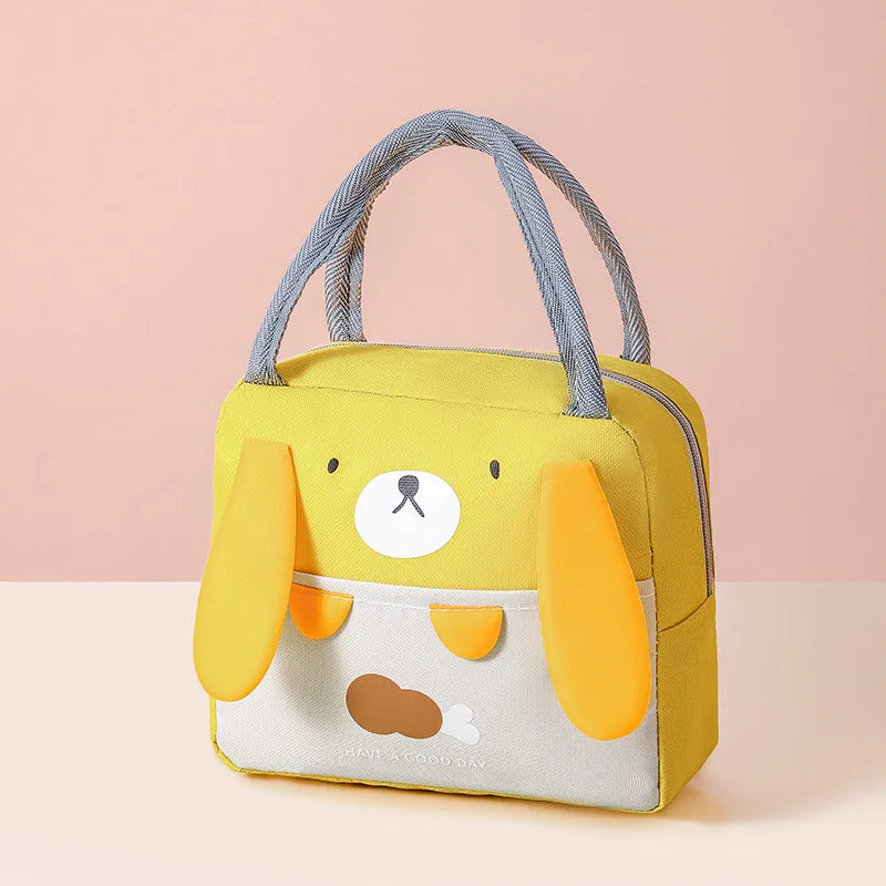 Yellow kawaii lunch bag with a cartoon dog face design on a pink background