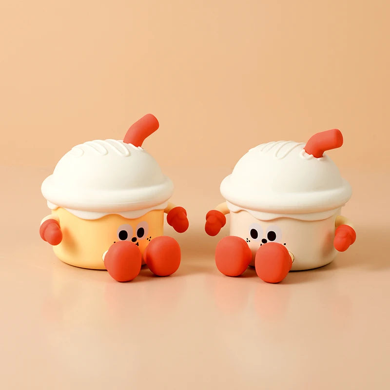 Two cute cartoon-like cupcake kawaii night lights with red legs and antennae on a beige background