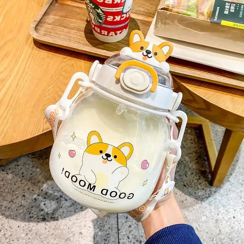 Hand holding a cute kawaii water bottle with a lid featuring cartoon dog designs on a wooden table.