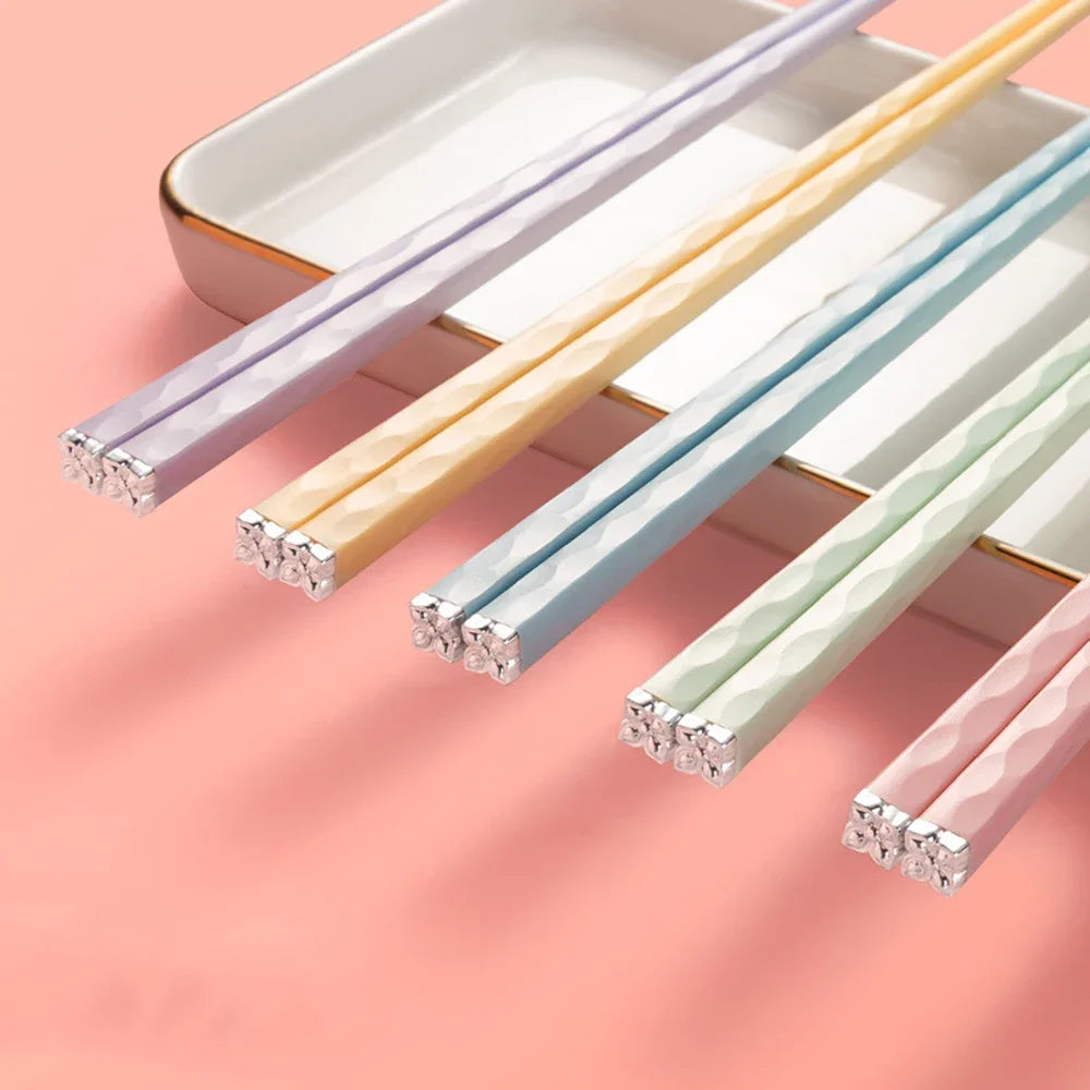 Set of colorful kawaii chopsticks on a pink background