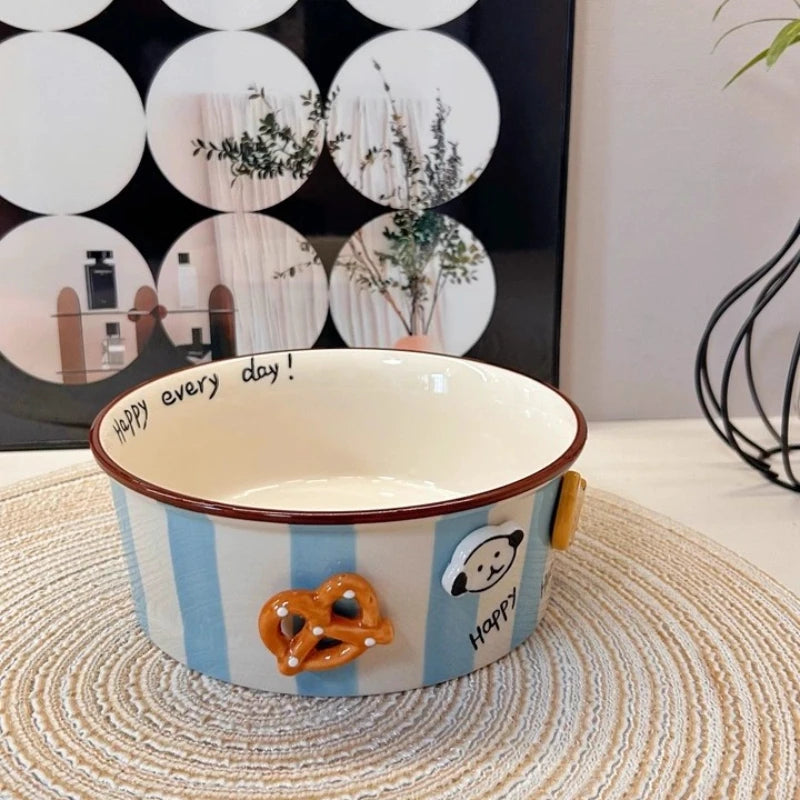 A striped kawaii ramen bowl with dog and pretzels on it