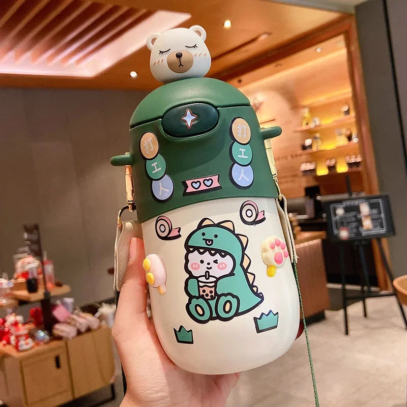 Colorful cartoon-themed kawaii water bottle with a bear on top held in a hand.