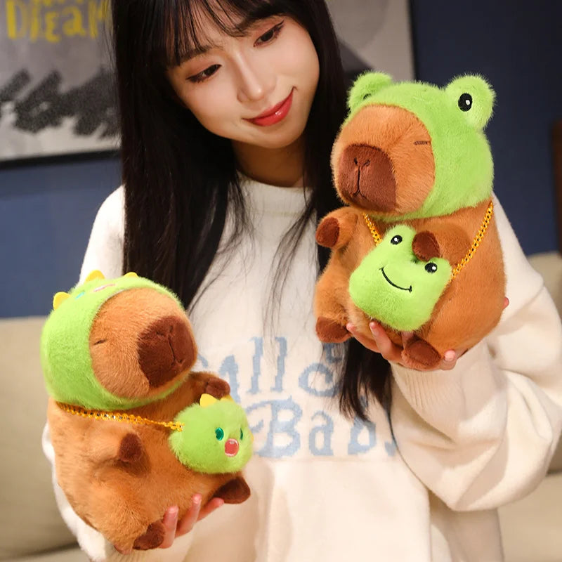 Person holding two kawaii plush toys resembling a brown animal with green frog heads.