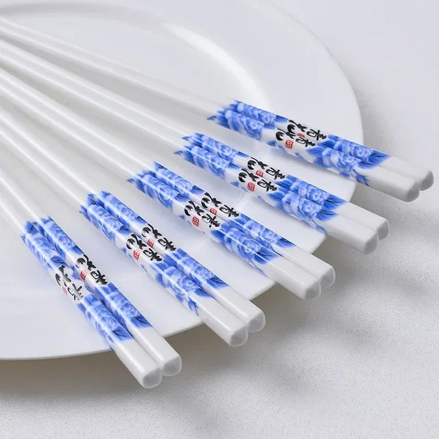 Set of kawaii chopsticks with blue floral patterns on a white plate