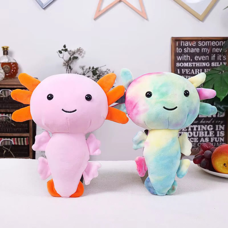 Two colorful plush toys resembling axolotls on a white surface with a decorative background.