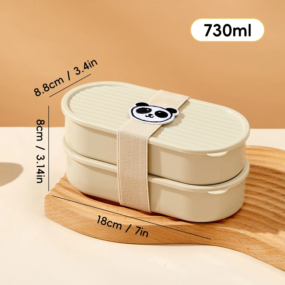 Kawaii beige bento box with panda design on lid, measurements shown, on a wooden stand.