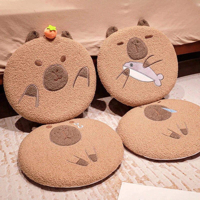 Four round, brown kawaii cushions with animal face designs on a textured surface.