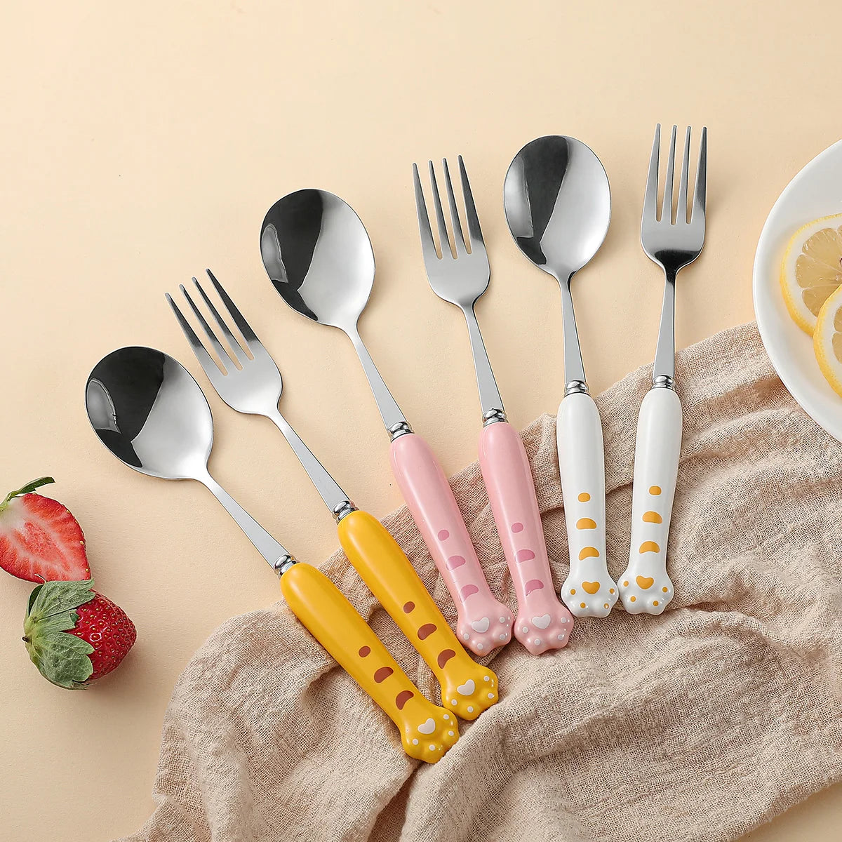 Three kawaii utensils in yellow, pink and white