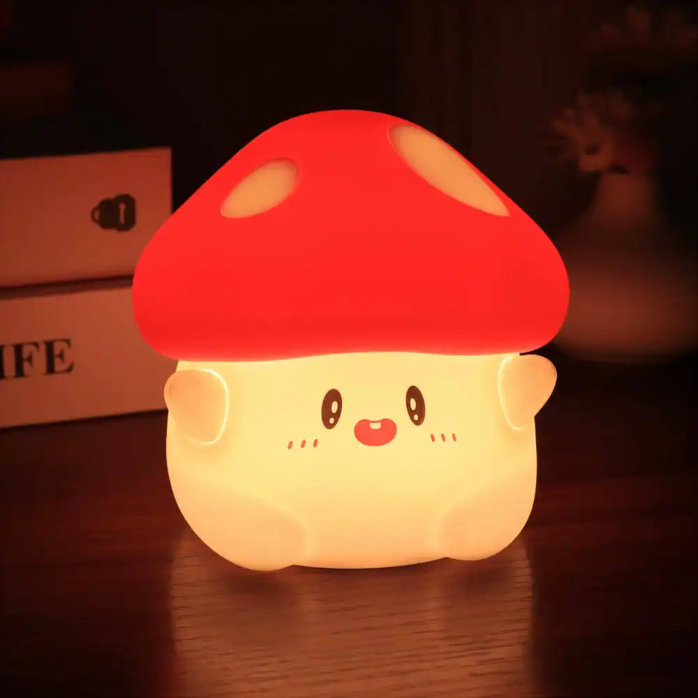 Cute mushroom-shaped kawaii night light with a red cap on a dark surface.