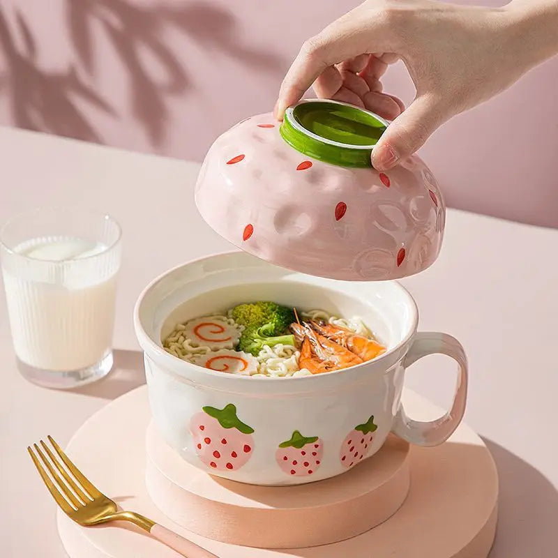 A strawberry shaped kawaii bowl with a pink lid